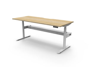 Rapidline Halo Plus electric height adjustable single sided workstation on 70mm diameter round columns, E0 rated Natural Oak top with a white satin powdercoated frame, fitted ducted cable tray. Rapidline range image supplied for model H+1PCT1575 NO/WS.