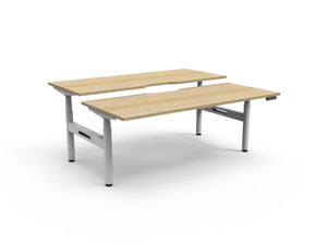 Rapidline Halo Plus electric height adjustable back to back workstation on 70mm diameter round columns, E0 rated Natural Oak top with a white satin powdercoated frame. Rapidline range image supplied for model H+2P1575 NO/WS.