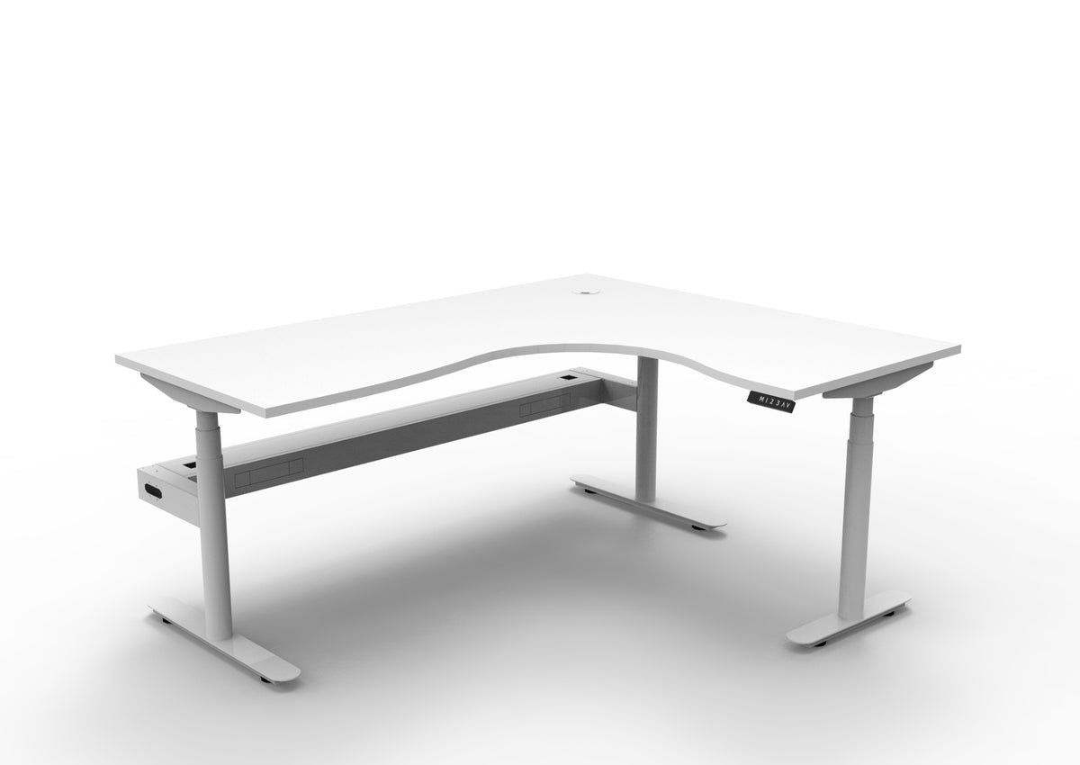 Rapidline Halo Plus electric height adjustable corner workstation on 70mm diameter round columns, E0 rated Natural White top with a white satin powdercoated frame, fitted ducted cable tray. Supplied product image for model H+CNRCT1P1815 NW/WS.