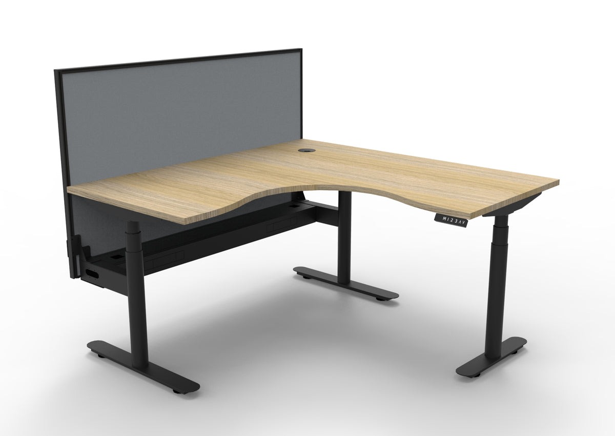 Rapidline Halo Plus electric height adjustable corner workstation on 70mm diameter round columns, E0 rated Natural Oak top with a black satin powdercoated frame, fitted ducted cable tray, 900mm black fabric privacy screen. Supplied product image for model H+CNRWSCT1P1515 NO/BL.