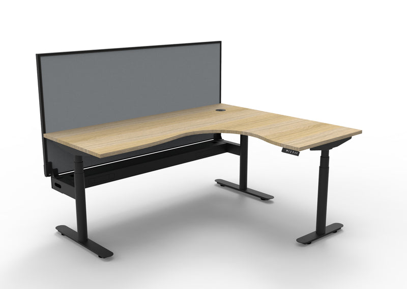 Rapidline Halo Plus electric height adjustable corner workstation on 70mm diameter round columns, E0 rated Natural Oak top with a black satin powdercoated frame, fitted ducted cable tray, 900mm black fabric privacy screen. Supplied product image for model H+CNRWSCT1P1815 NO/BL.