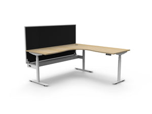 Rapidline Halo Plus electric height adjustable corner workstation on 70mm diameter round columns, E0 rated Natural Oak top with a white satin powdercoated frame, fitted ducted cable tray, 900mm black fabric privacy screen. Supplied product image for model H+CNRWSCT1P1818 NO/WS.