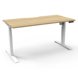 Rapidline Boost Light single sided electric sit-stand desk with a natural oak top on a white frame, with the controller at the front right edge