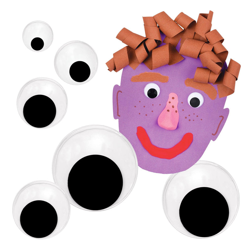 Joggle eyes in several sizes beside a craft face made with them