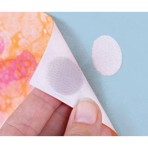 Hook and loop dot being attached to patterned paper