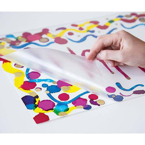 Artwork being placed inside an A4 laminating pouch