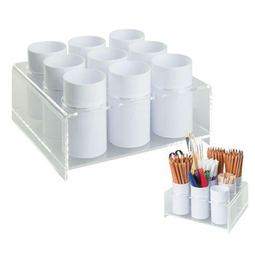 Display and storage holder beside a cup of pencils and brushes
