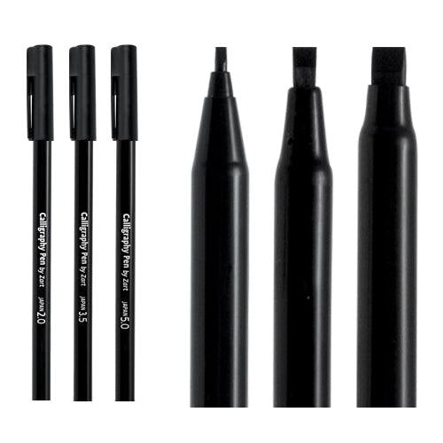Three black calligraphy pens standing with nibs shown