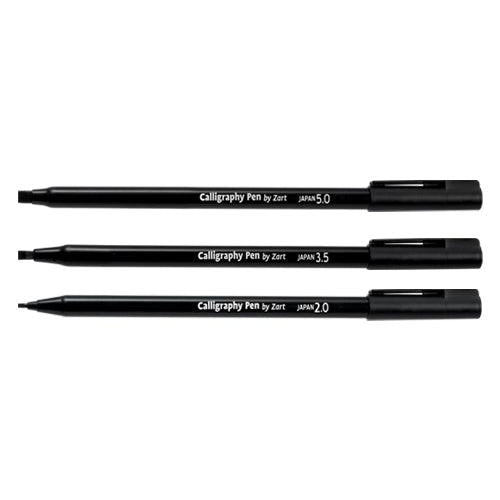 Three black calligraphy pens laid side by side