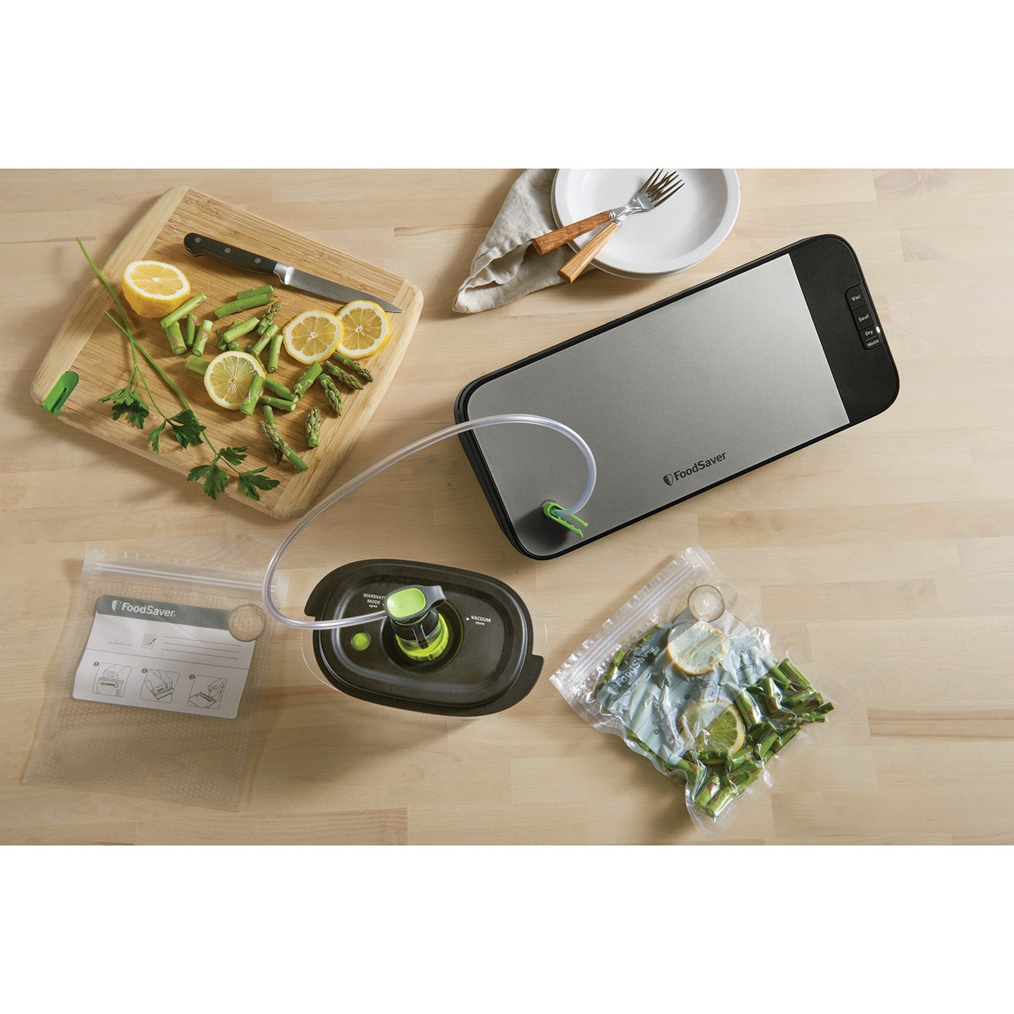 FoodSaver VS2198 handheld sealer in use with container
